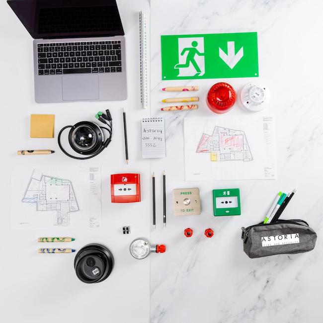 laptop, fire safety equipment laid down on flat surface